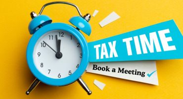 clock and note to remind you to book a tax meeting