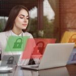 Woman at a desk in front of a laptop with graphic locks floating around her suggesting data security.