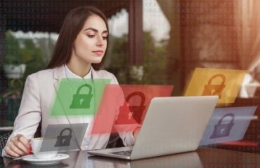 Woman at a desk in front of a laptop with graphic locks floating around her suggesting data security.