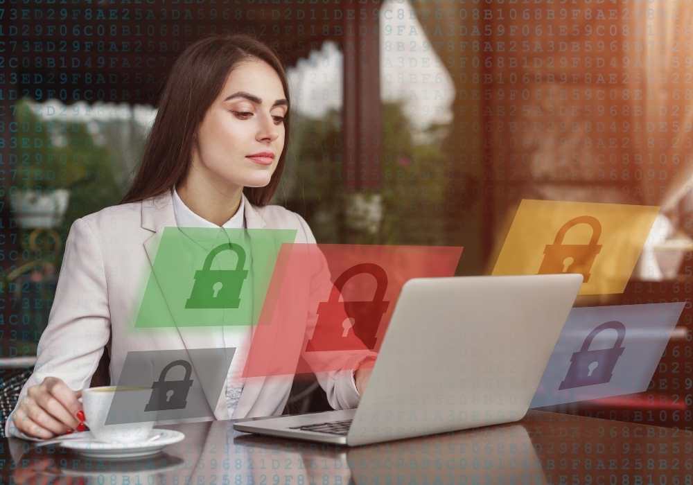 Woman at a desk in front of a laptop with graphic locks floating around her suggesting data security.