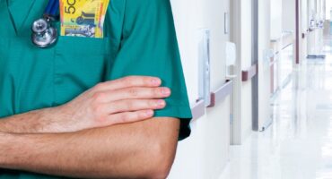 doctor in a hospital with money in his pocket