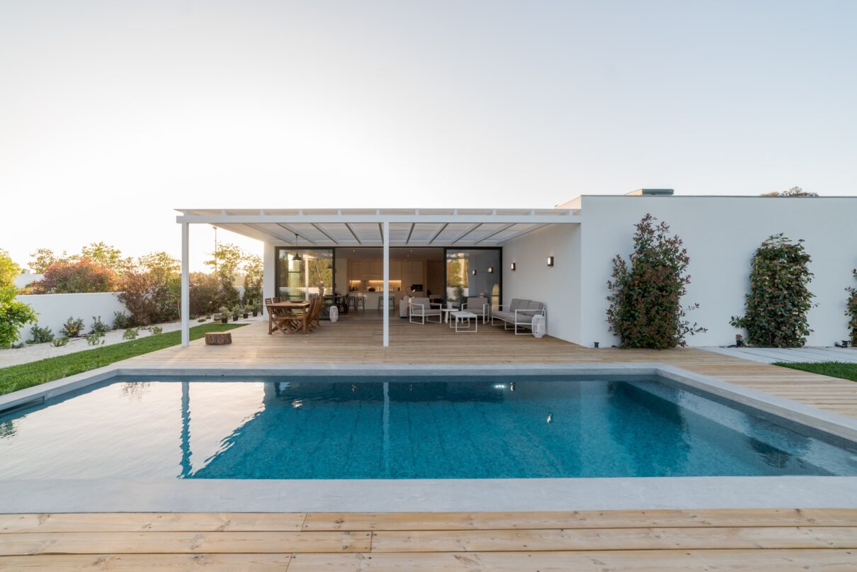 Modern house with garden swimming pool and wooden deck