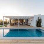 Modern house with garden swimming pool and wooden deck